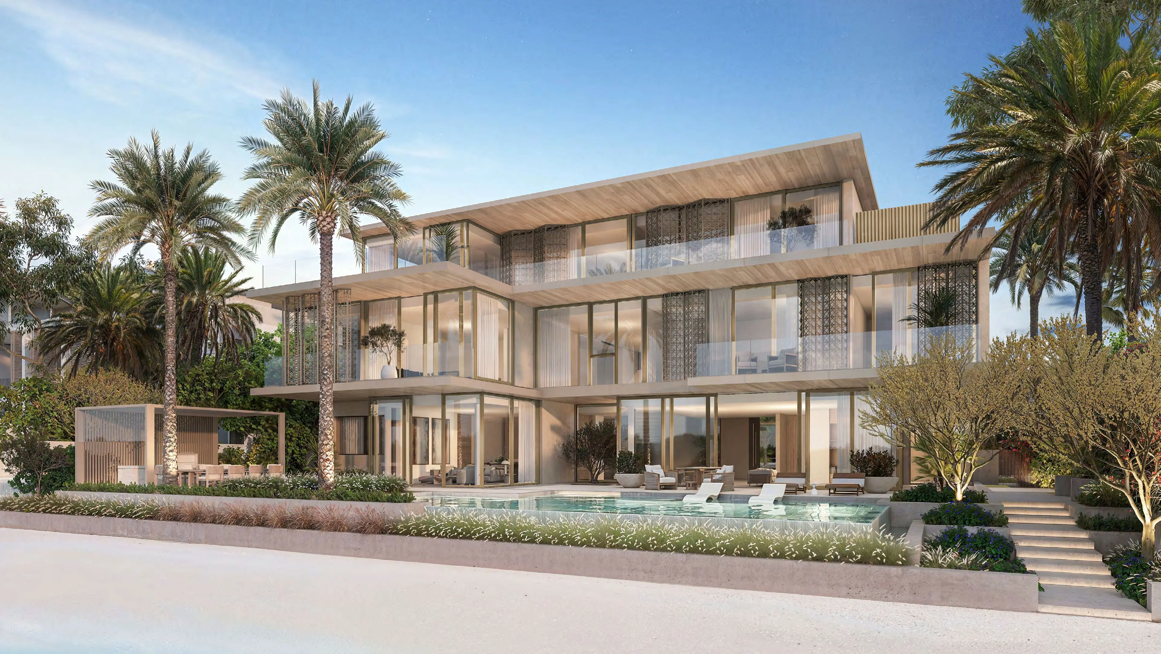 Beach Collection villa seen from the sand, with pool terrace and full-height glazing