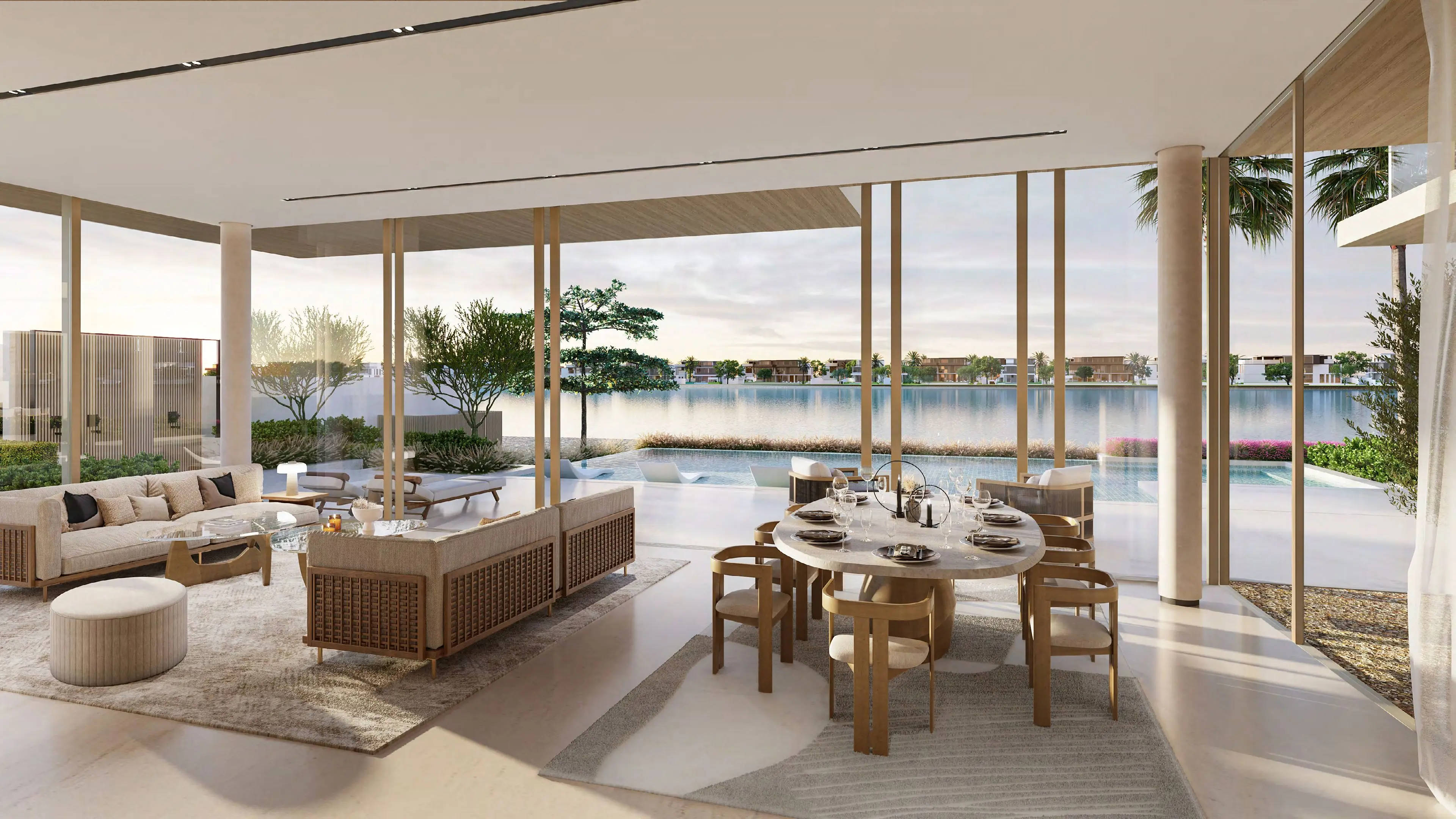 Open-plan living and dining space at sunset with pool and lagoon beyond